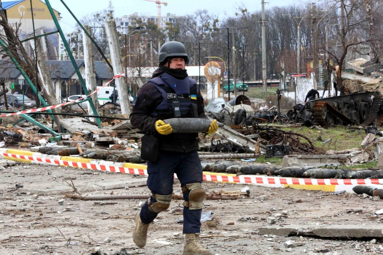 рятувальник несе міну, вибухівка, розмінування