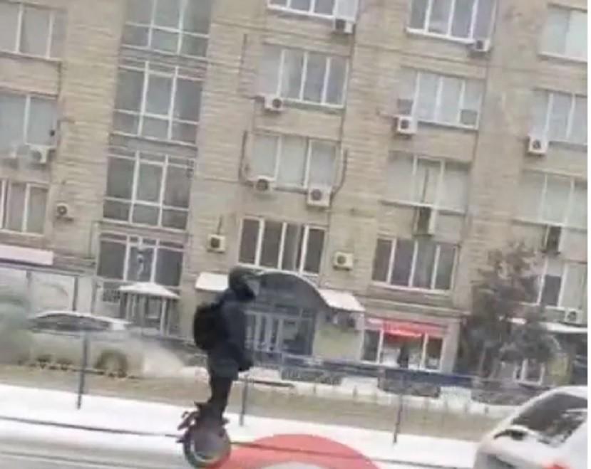 Обганяв машини на засніженій дорозі: у Києві помітили чоловіка на моноколесі